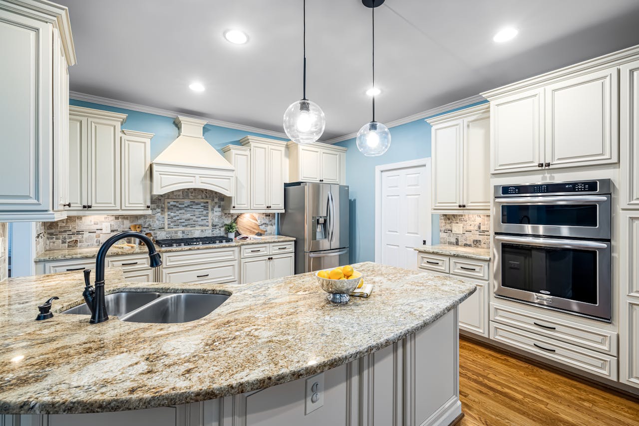 Stylish kitchen interior featuring marble countertops, stainless steel appliances, and custom cabinetry.